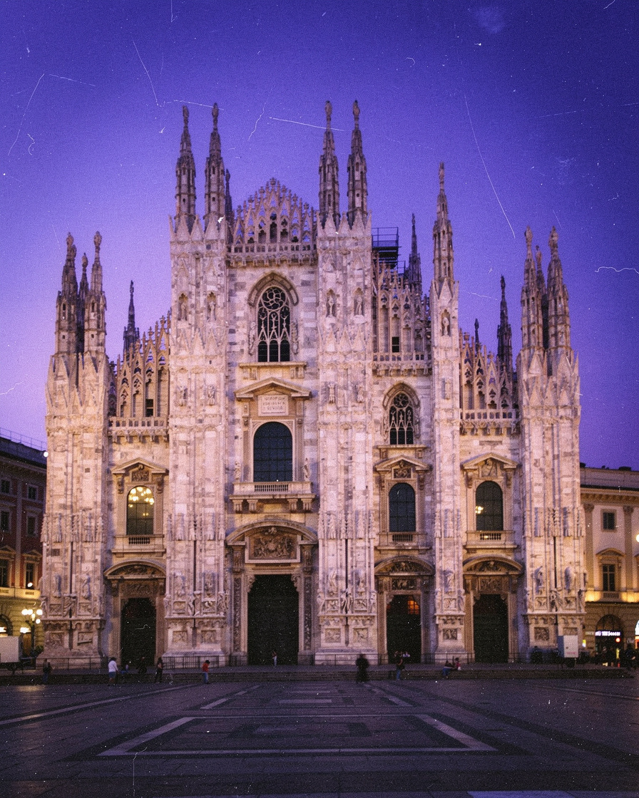 duomo milan dusk photography: Spires of the Duomo di Milano against a violet dusk sky, white marble facade glowing under floo