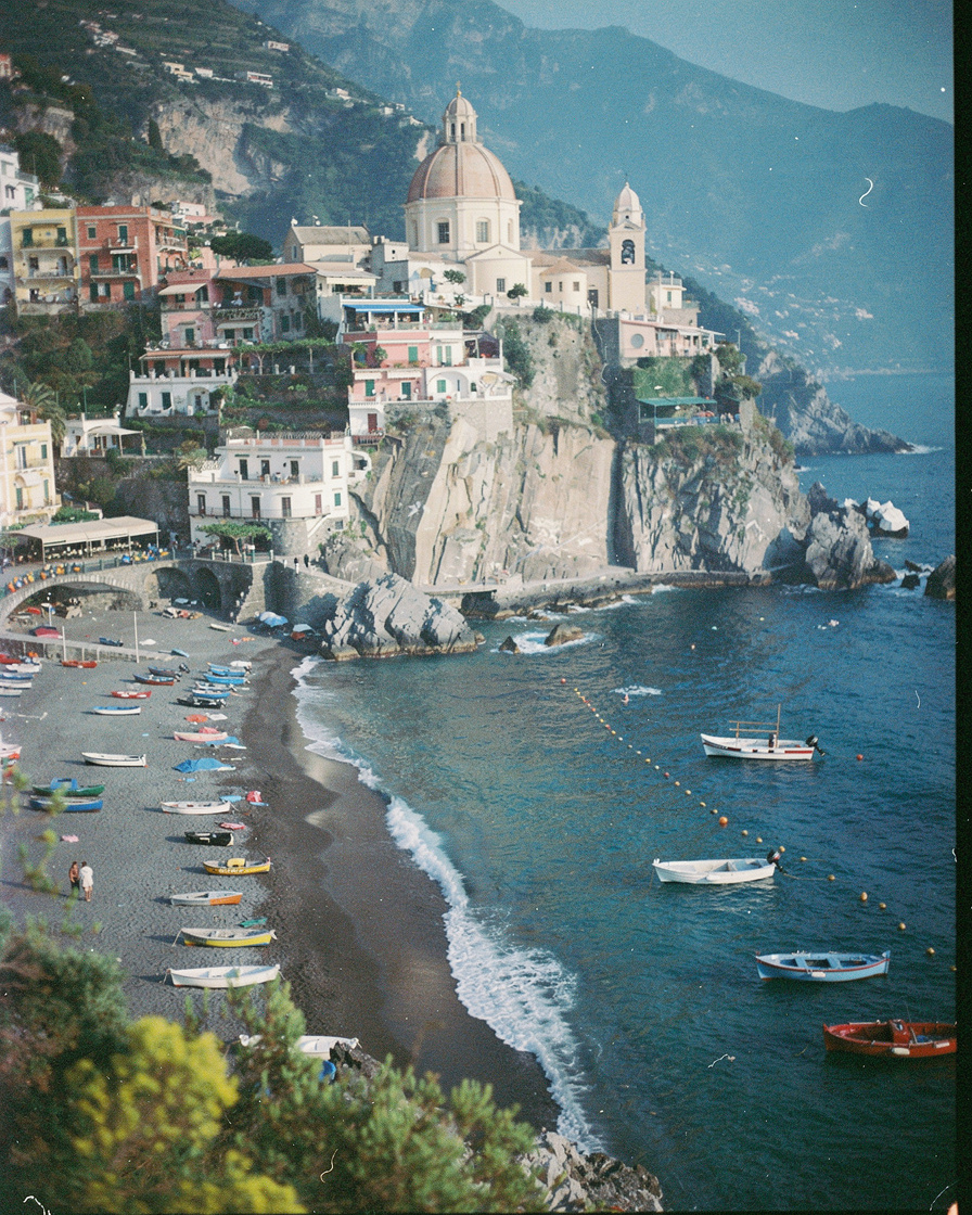 positano amalfi coast morning: Cliffside houses of Positano stacked down to the sea with the tiled dome of Santa Maria Assunt
