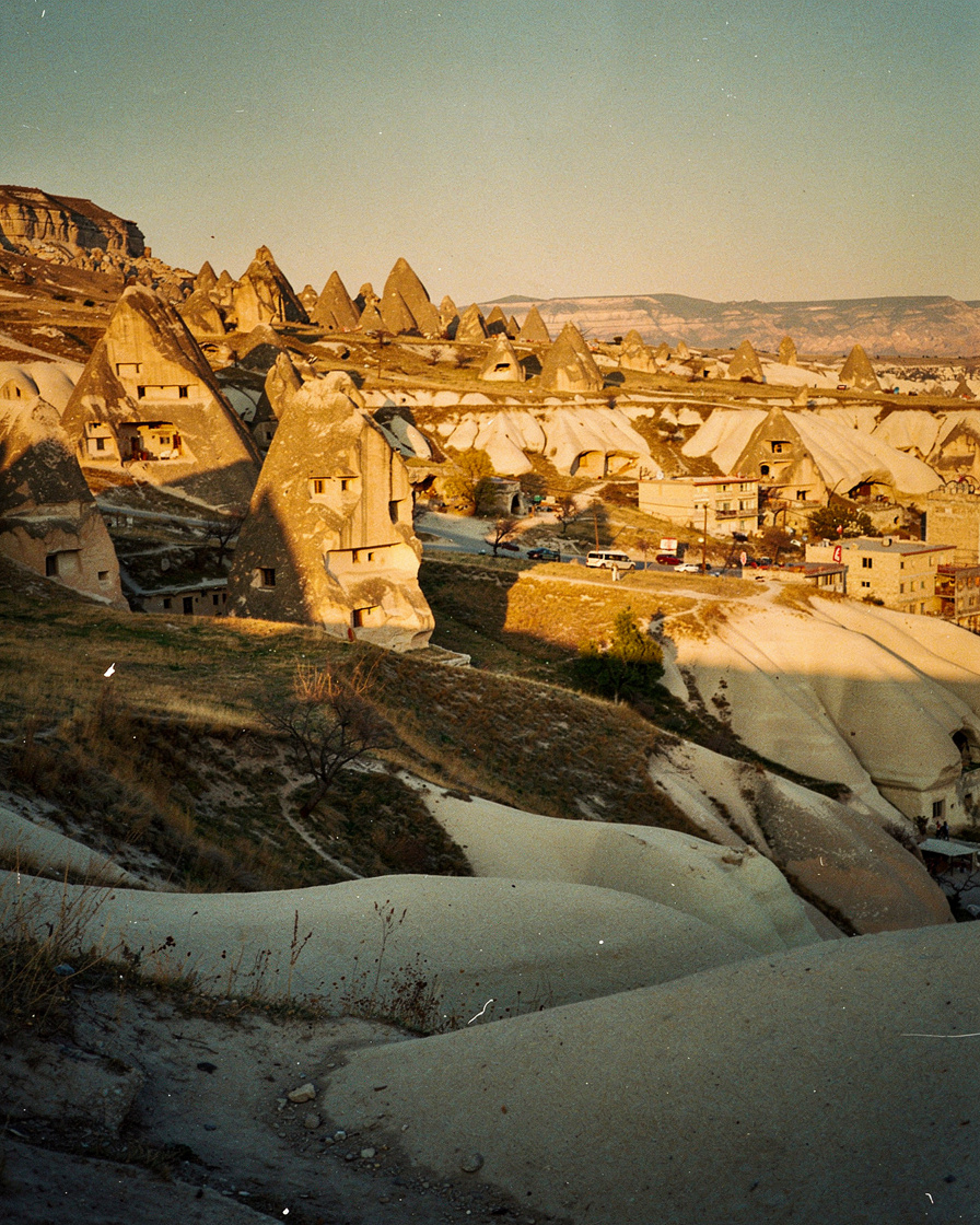 cappadocia golden hour: Fairy chimneys and cave dwellings in Cappadocia, Turkey, glowing amber in golden hour light with long
