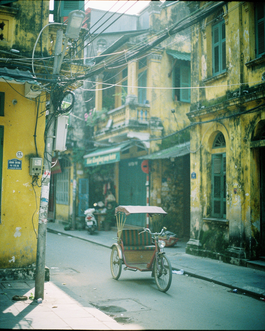 hanoi old quarter morning: Empty narrow Hanoi Old Quarter street with faded yellow French-colonial buildings, tangled wires o